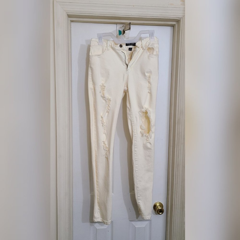 Cream color skinny jeans with rips in legs(stretch denim size 11)